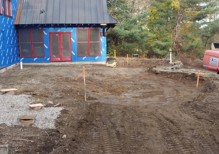 Site prepared and staked out for a new natural stone patio in Bolton Massachusetts M Coelho Group