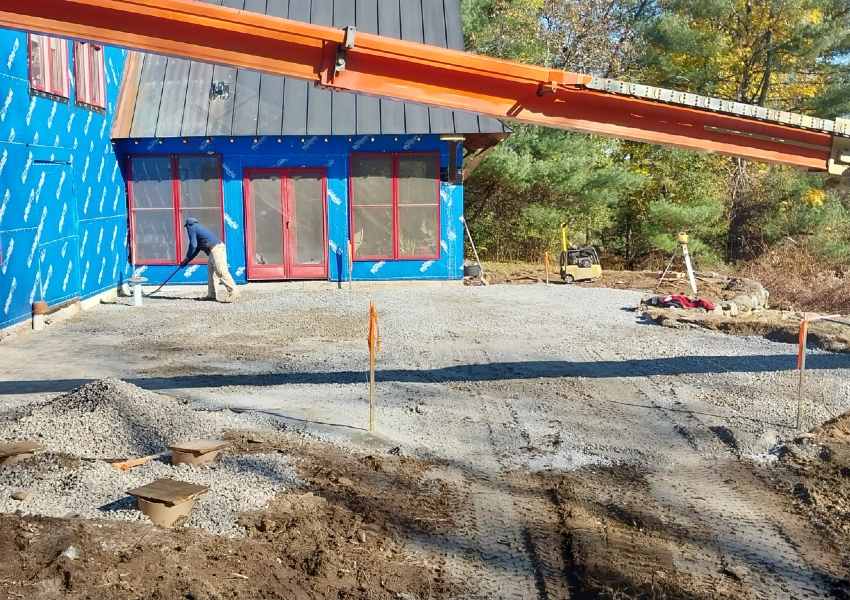 Spreading and grading the crushed stone base for a stone patio in Bolton Massachusetts M Coelho Group