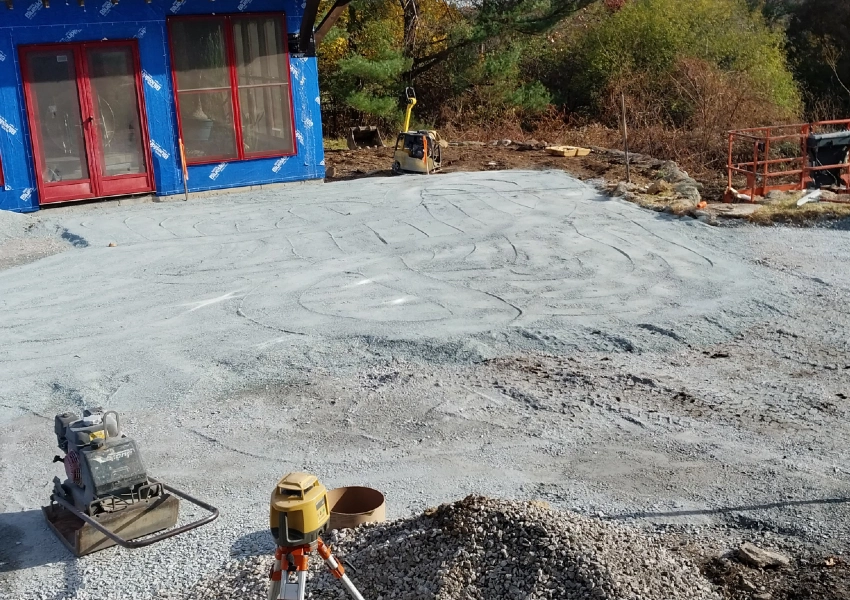 Compacting and laser-leveling the base for a natural stone patio in Bolton Massachusetts M Coelho Group