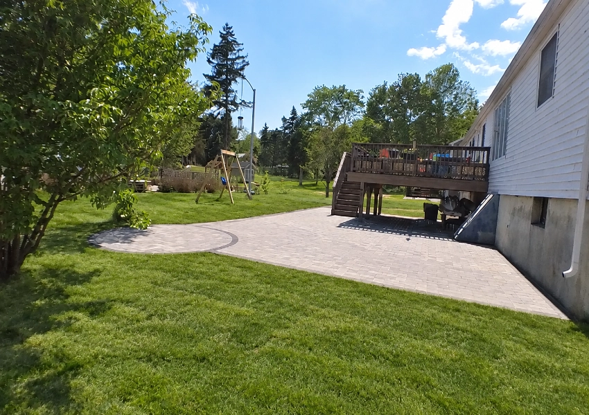 Finished curved brick walkway with new plantings at a new construction home in Northborough Massachusetts M Coelho Group