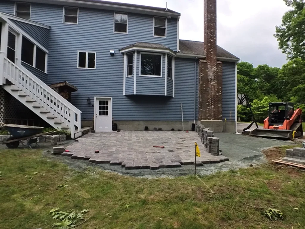 Laying the paver patio over the prepared base in Ashland Massachusetts M Coelho Group